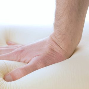 hand-is-pressing-a-memory-foam-mattress